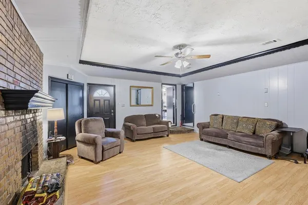 a living room with furniture a fireplace and a flat screen tv
