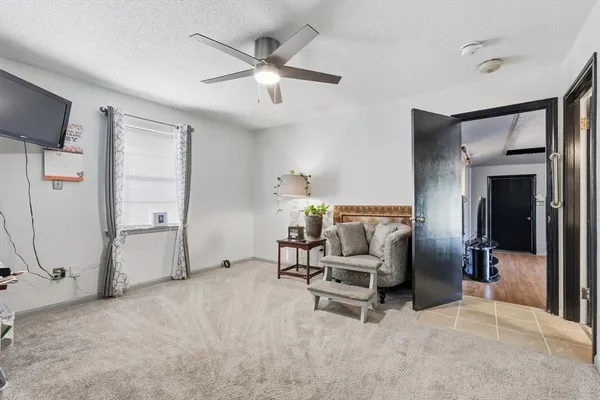 a view of a livingroom with furniture and a ceiling fan