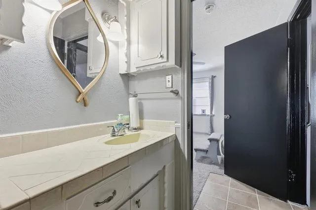 a bathroom with a sink a vanity and a mirror