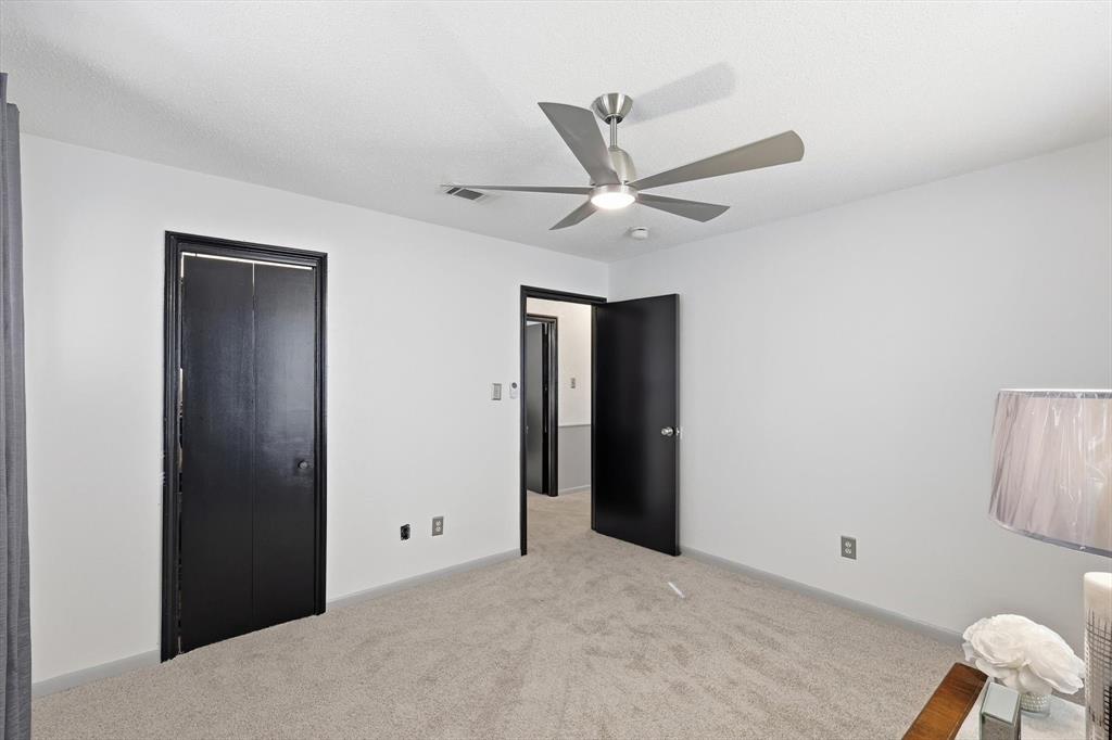 910 Rockwall Street McKinney, TX 75069 - Photo 20 of 34 Unfurnished bedroom featuring light colored carpet, a ceiling fan, and a closet