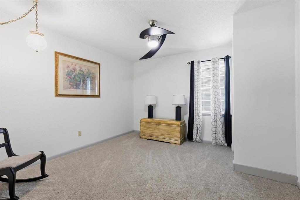 910 Rockwall Street McKinney, TX 75069 - Photo 21 of 34 Unfurnished room featuring light carpet and a textured ceiling