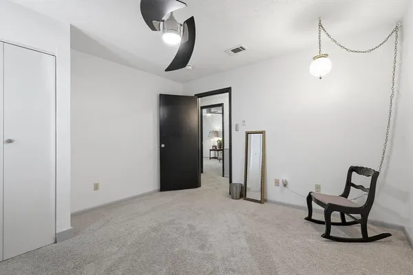 a view of a livingroom with furniture and closet area