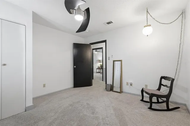 a view of a livingroom with furniture and closet area