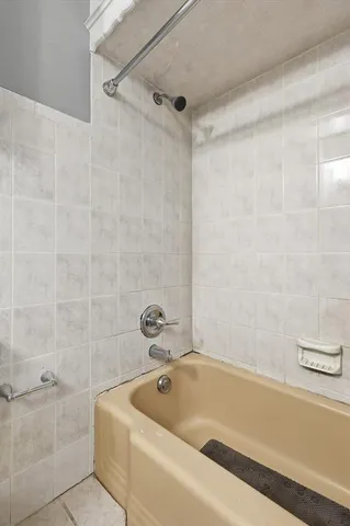 a bathroom with a tub and a shower