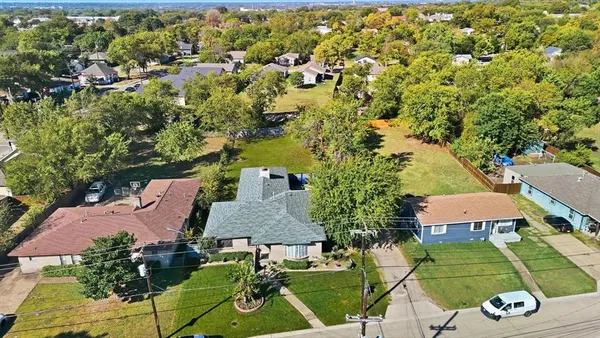 an aerial view of a house with garden space and street view