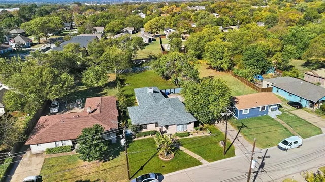 an aerial view of residential houses with outdoor space and street view
