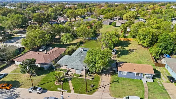 an aerial view of a house with a yard