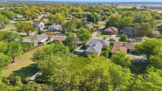 an aerial view of residential house with outdoor space and trees all around
