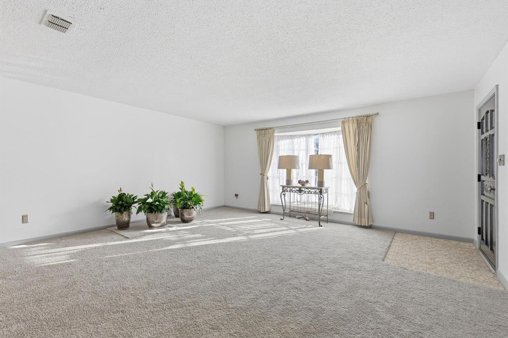 910 Rockwall Street McKinney, TX 75069 - Photo 7 of 34 Carpeted empty room with a textured ceiling