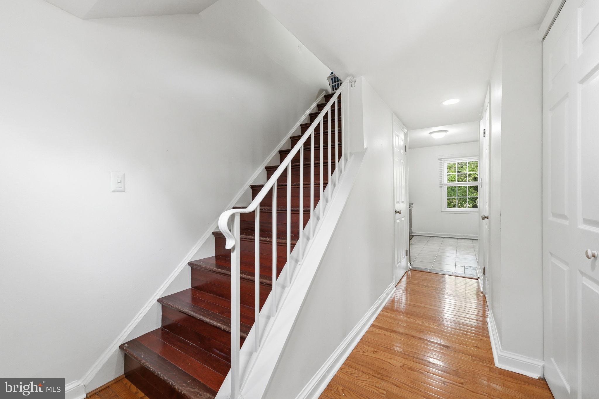 8260 Getty Court Springfield, VA 22153 - Photo 3 of 31 a view of a hallway with wooden floor and staircase