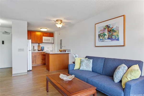 a living room with furniture and kitchen view