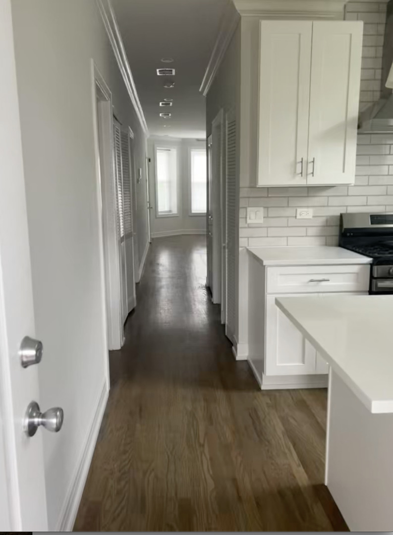 3839 West 14th Street, Unit 1 Chicago, IL 60623 - Photo 2 of 10 a view of a hallway with wooden floor and staircase