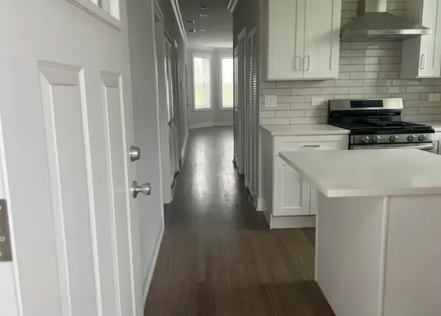 a kitchen with a refrigerator and a stove