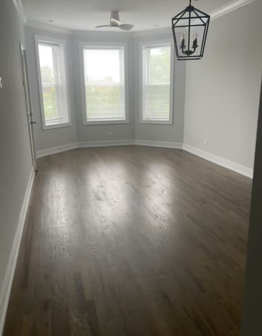 3839 West 14th Street, Unit 1 Chicago, IL 60623 - Photo 5 of 10 an empty room with wooden floor and windows