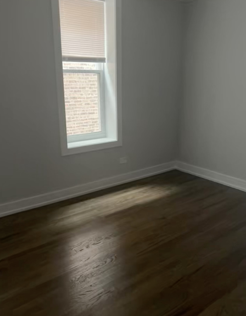 3839 West 14th Street, Unit 1 Chicago, IL 60623 - Photo 6 of 10 an empty room with wooden floor and windows