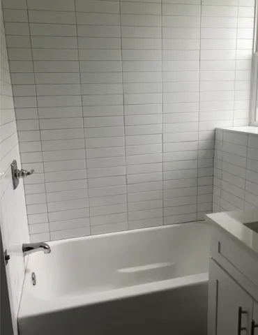 a bathroom with a bathtub and shower