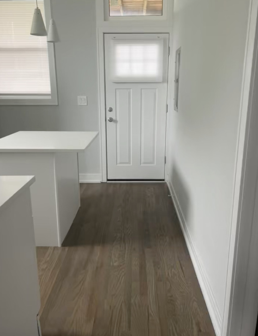 3839 West 14th Street, Unit 1 Chicago, IL 60623 - Photo 8 of 10 a view of a hallway with wooden floor and staircase