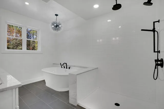 a bathroom with a sink mirror and shower