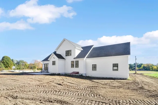 a view of a white house with a yard