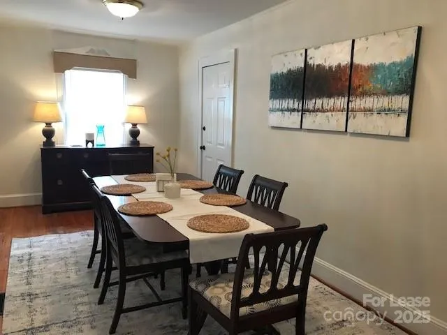 a view of a dining room that has a table and chairs in it