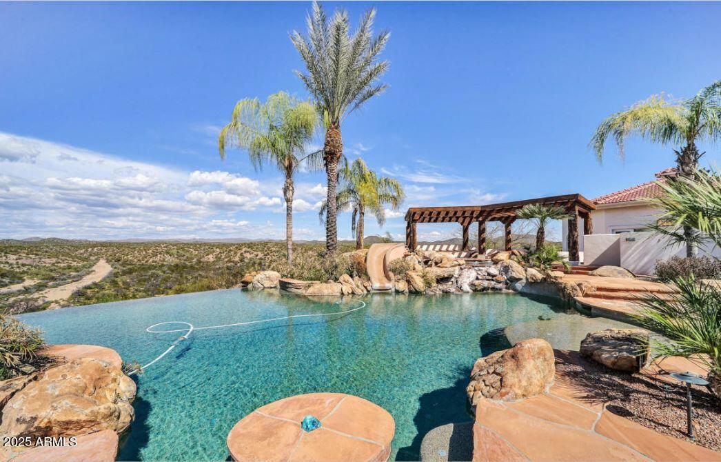 28331 West Rocking Horse Lane Morristown, AZ 85342 - Photo 16 of 22 a view of a swimming pool with a yard