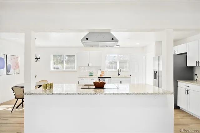 a view of living room with granite countertop furniture and a flat screen tv