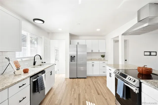 a kitchen with a sink stove and refrigerator