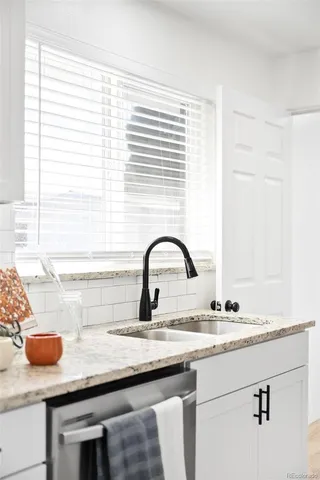 a kitchen with a sink and a window