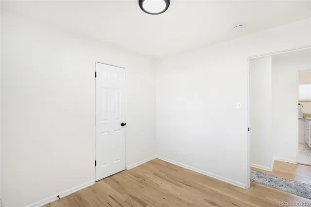 a view of a room with wooden floor and glass door