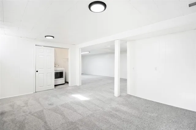 a view of empty room with white walls