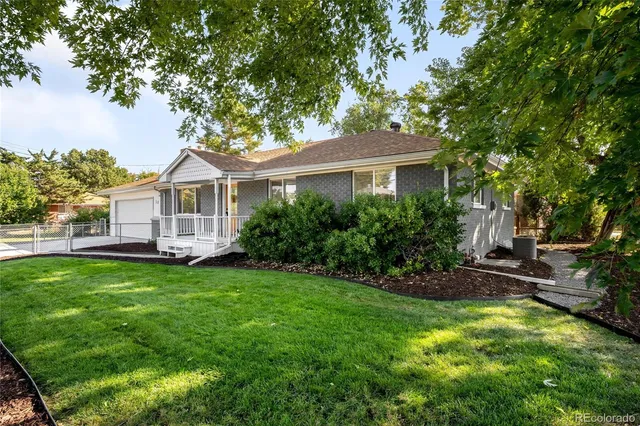 a view of a house with a yard and sitting area