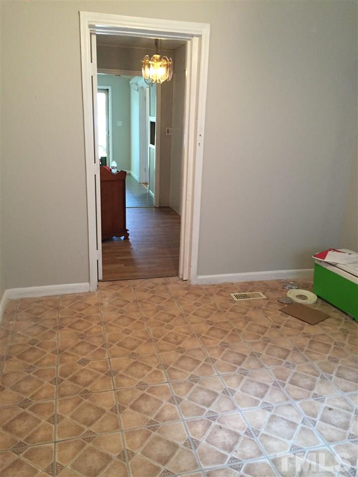 1005 Beverly Drive Raleigh, NC 27610 - Photo 4 of 10 a view of a hallway with wooden floor and a livingroom