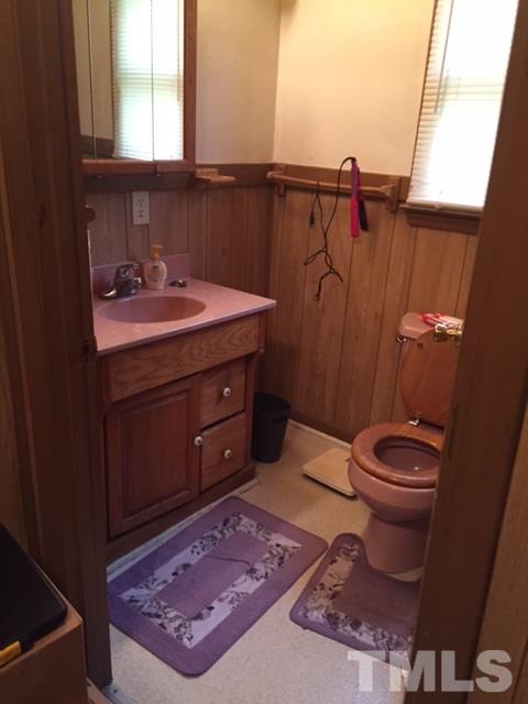 1005 Beverly Drive Raleigh, NC 27610 - Photo 10 of 10 a bathroom with a sink a toilet and a mirror