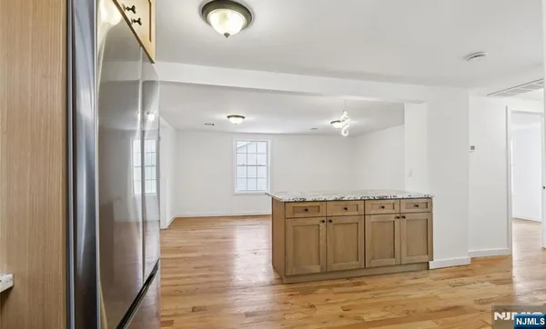 a view of a kitchen with a sink and a wooden floor