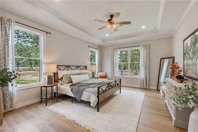 a spacious bedroom with a large bed and a chandelier
