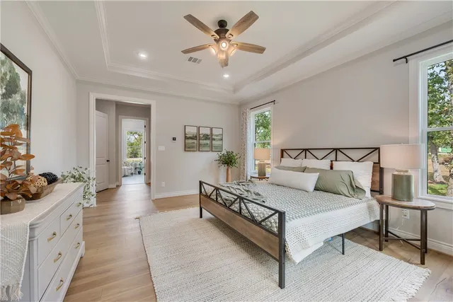 a spacious bedroom with a bed and ceiling fan