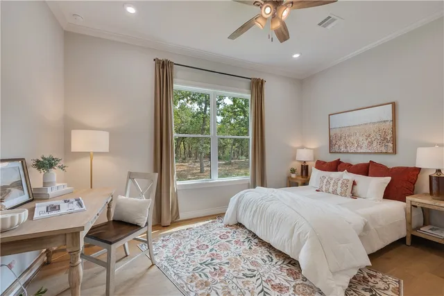 a bedroom with a large bed and a window