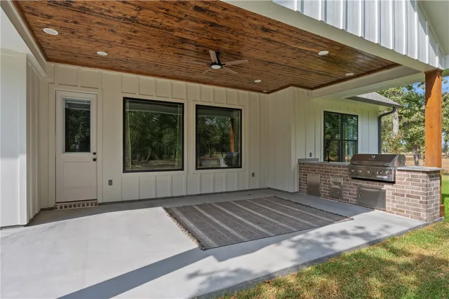 a view of a backyard with wooden floor and a fireplace