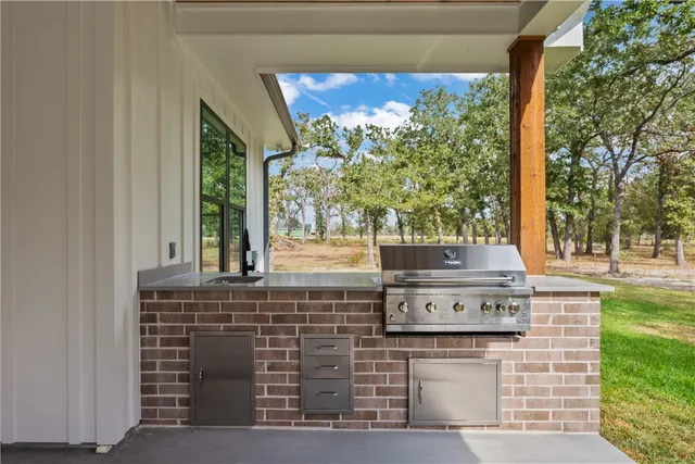 a stove top oven sitting next to a yard