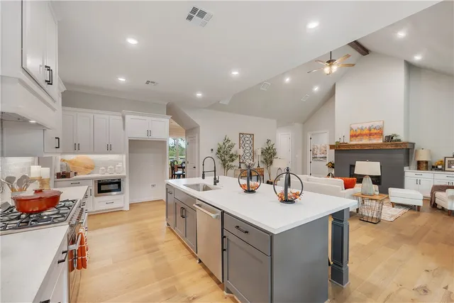 a kitchen with counter top space a sink cabinets and appliances