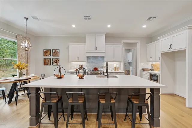 a view of a dining room and kitchen with a table chairs and a refrigerator