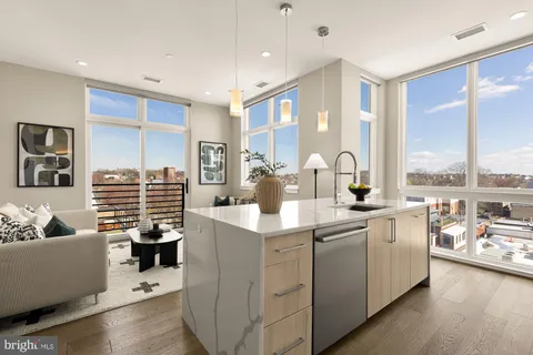 a kitchen with center island a sink appliances and a large window