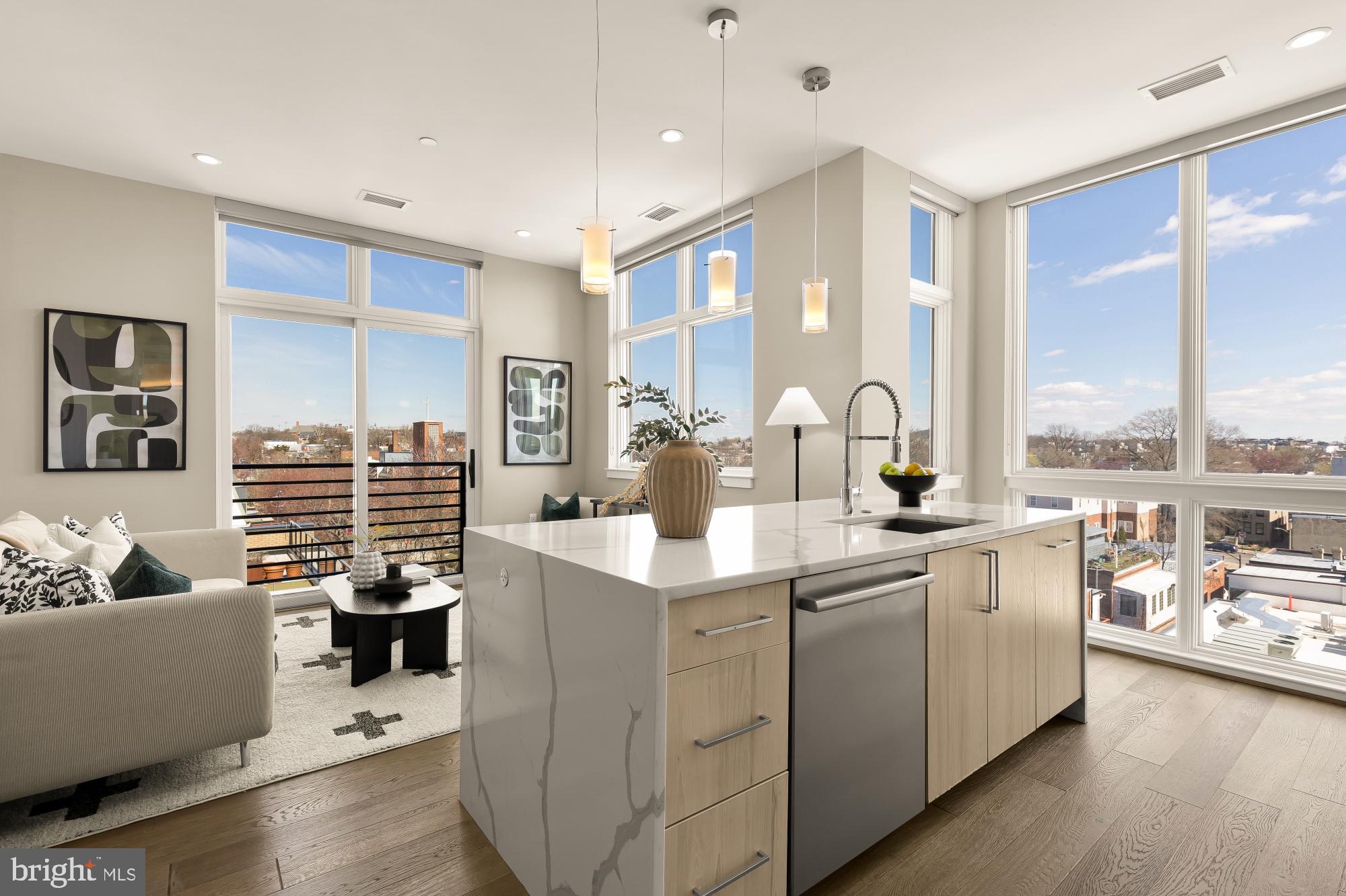 a kitchen with center island a sink appliances and a large window