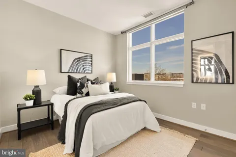 a bedroom with a bed and a painting on the wall