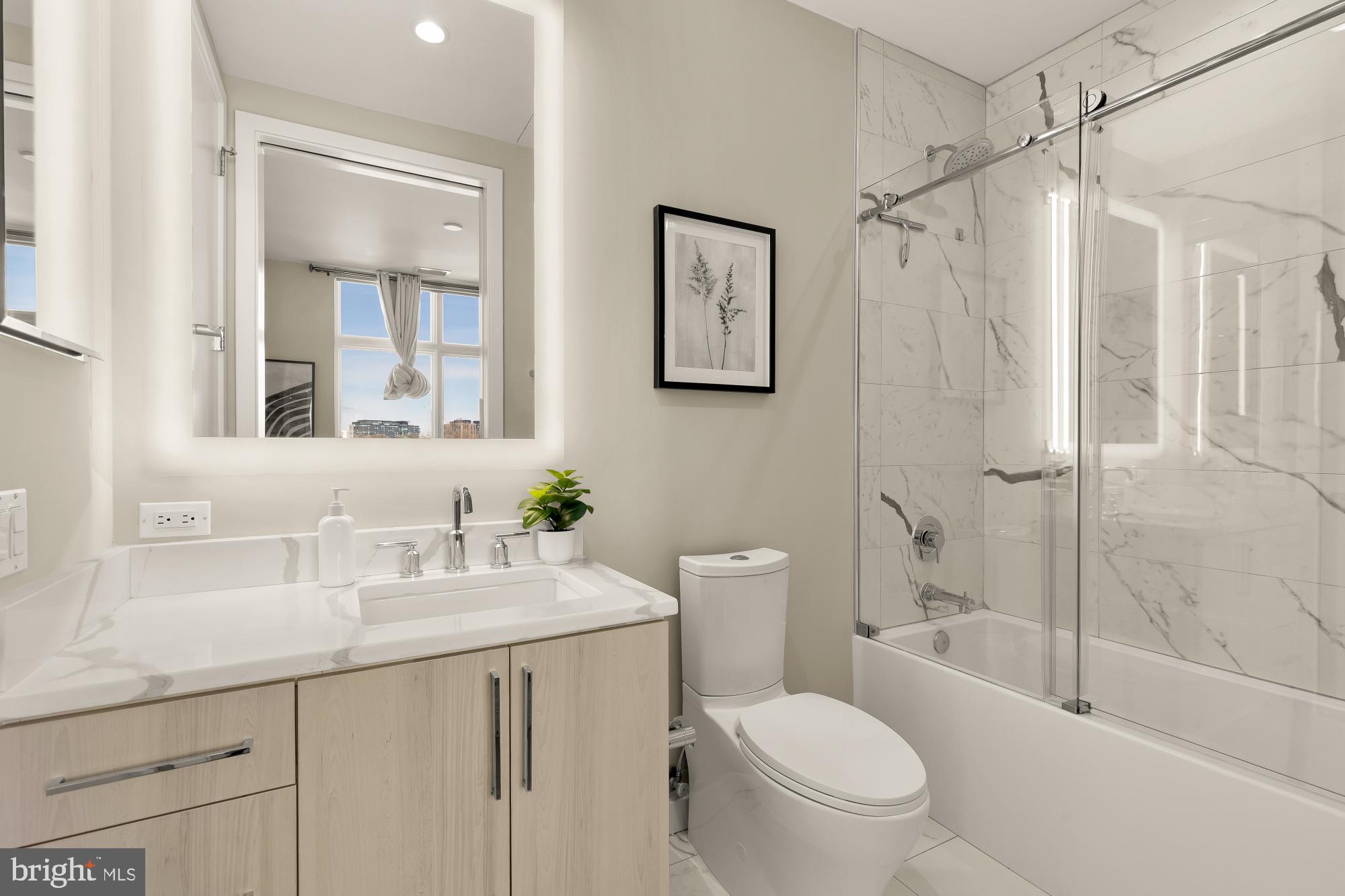 646 H Street Northeast, Unit 503 Washington, DC 20002 - Photo 20 of 26 a bathroom with a sink a toilet and shower
