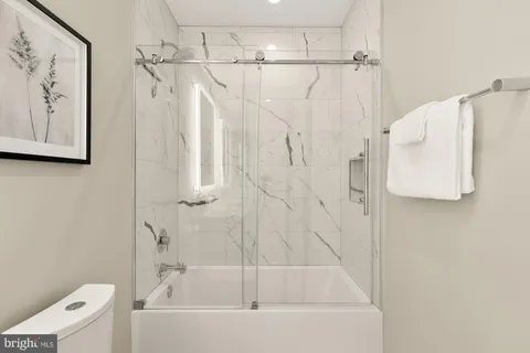 a bathroom with a bathtub and a shower
