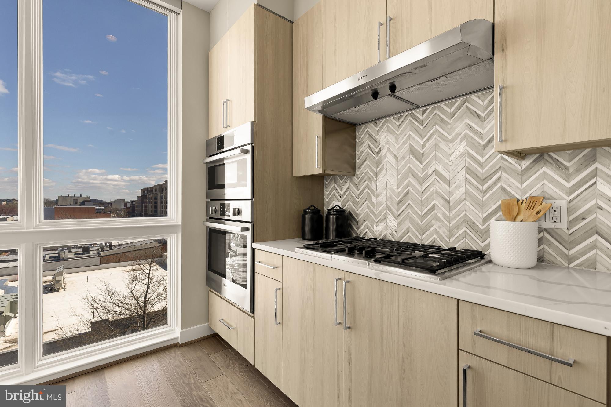 646 H Street Northeast, Unit 503 Washington, DC 20002 - Photo 7 of 26 a kitchen with stainless steel appliances granite countertop a stove and a microwave
