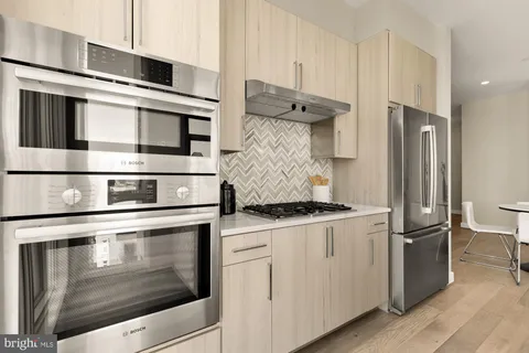 a kitchen with stainless steel appliances granite countertop a stove and a refrigerator