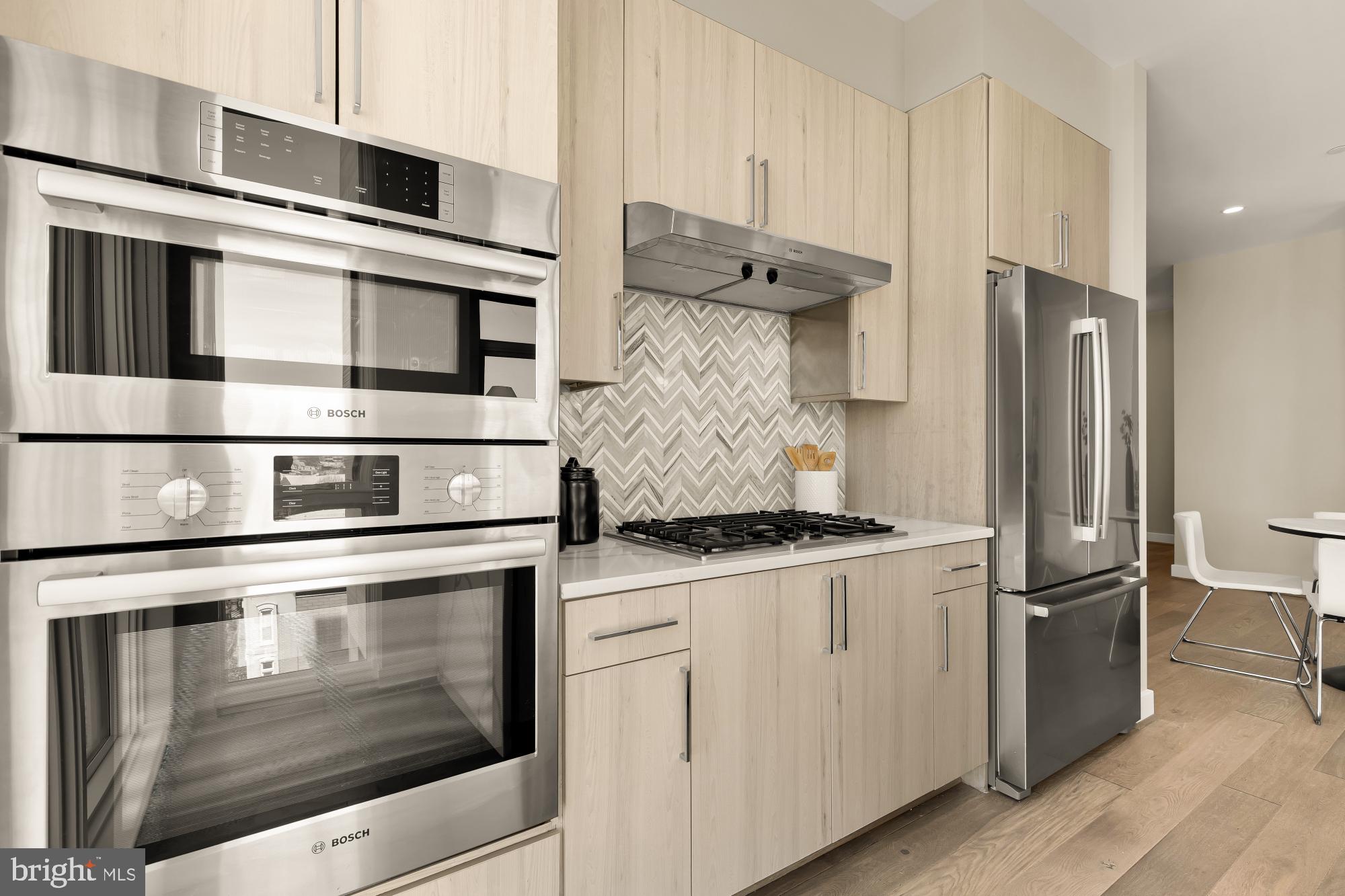 646 H Street Northeast, Unit 503 Washington, DC 20002 - Photo 8 of 26 a kitchen with stainless steel appliances granite countertop a stove and a refrigerator