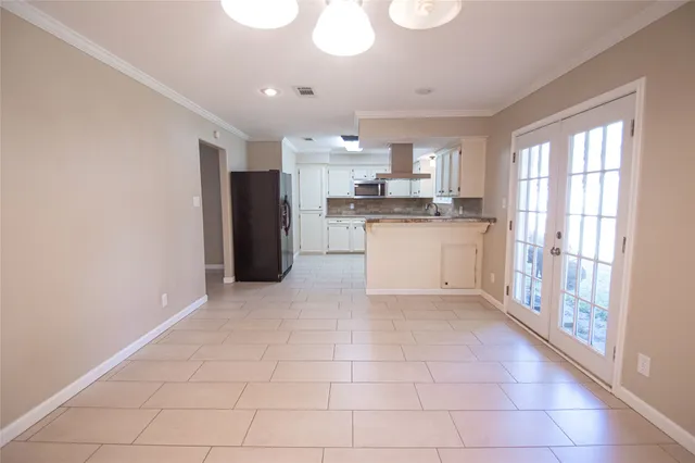 a kitchen with a refrigerator and a stove top oven